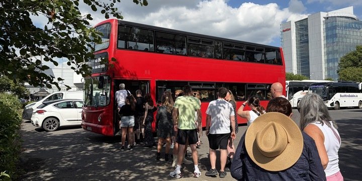 Concert Express bus to Marlay Park Concerts people in queue to get onto red bus