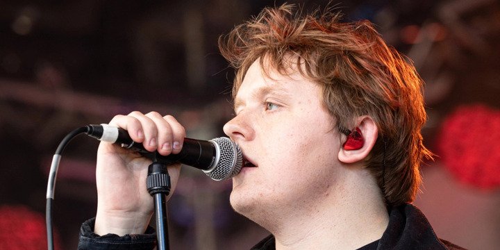 man singing into mic