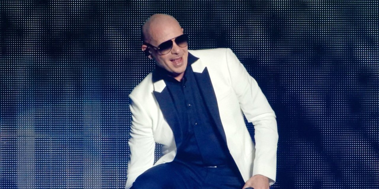 bald man with sunglasses in suit dancing