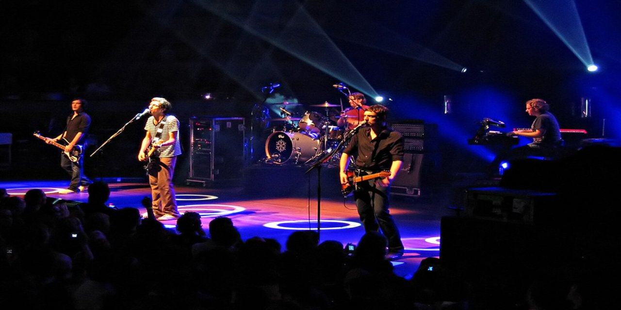 Band o dark stages with strobe liights
