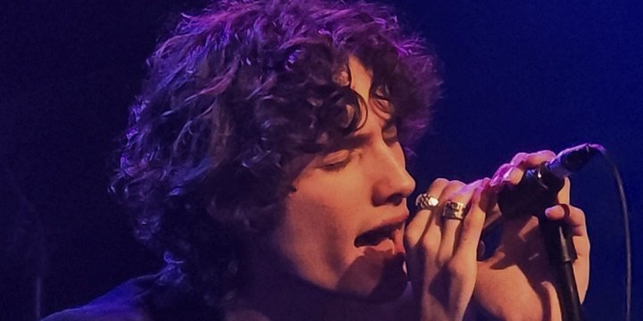 man singing into mic